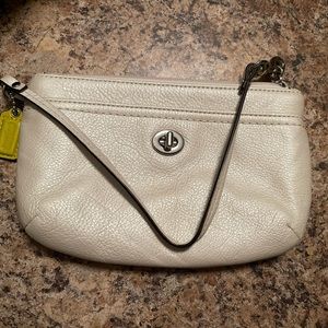 Coach wristlet. Carried a handful of times. No scratches, scuffs or damage.